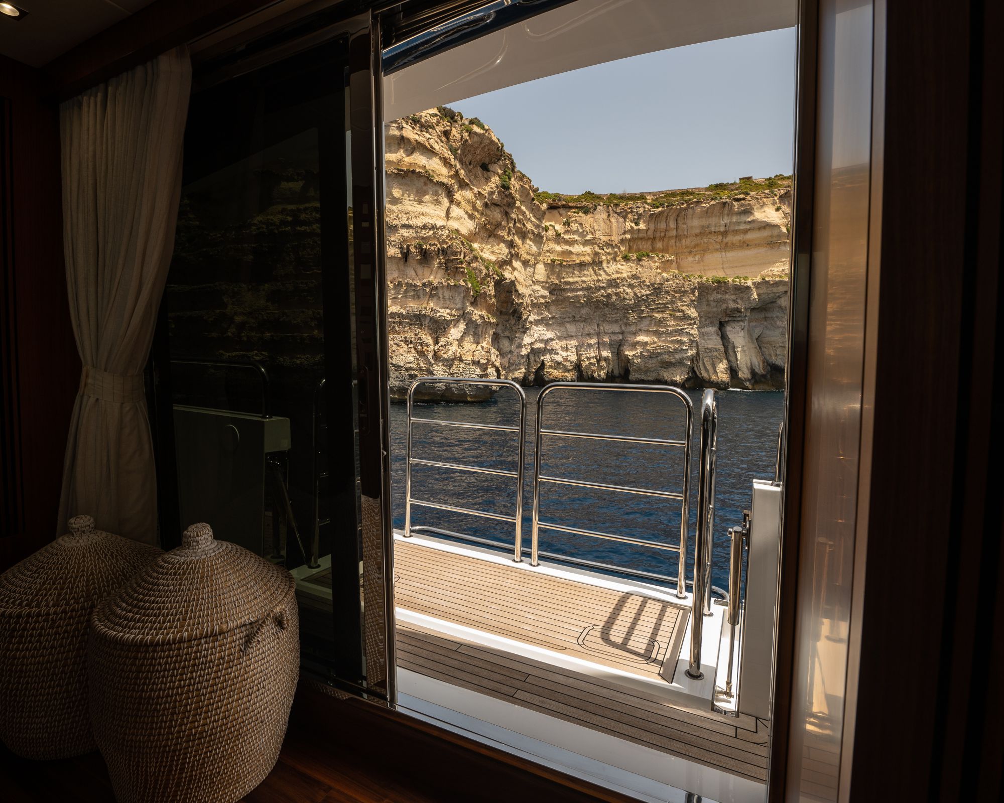 Superyacht anchored in a secluded Mediterranean bay near Malta